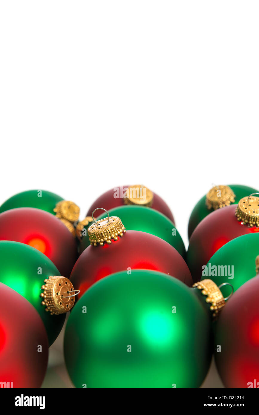 Red and green shiny Christmas ornaments on a white background Stock Photo
