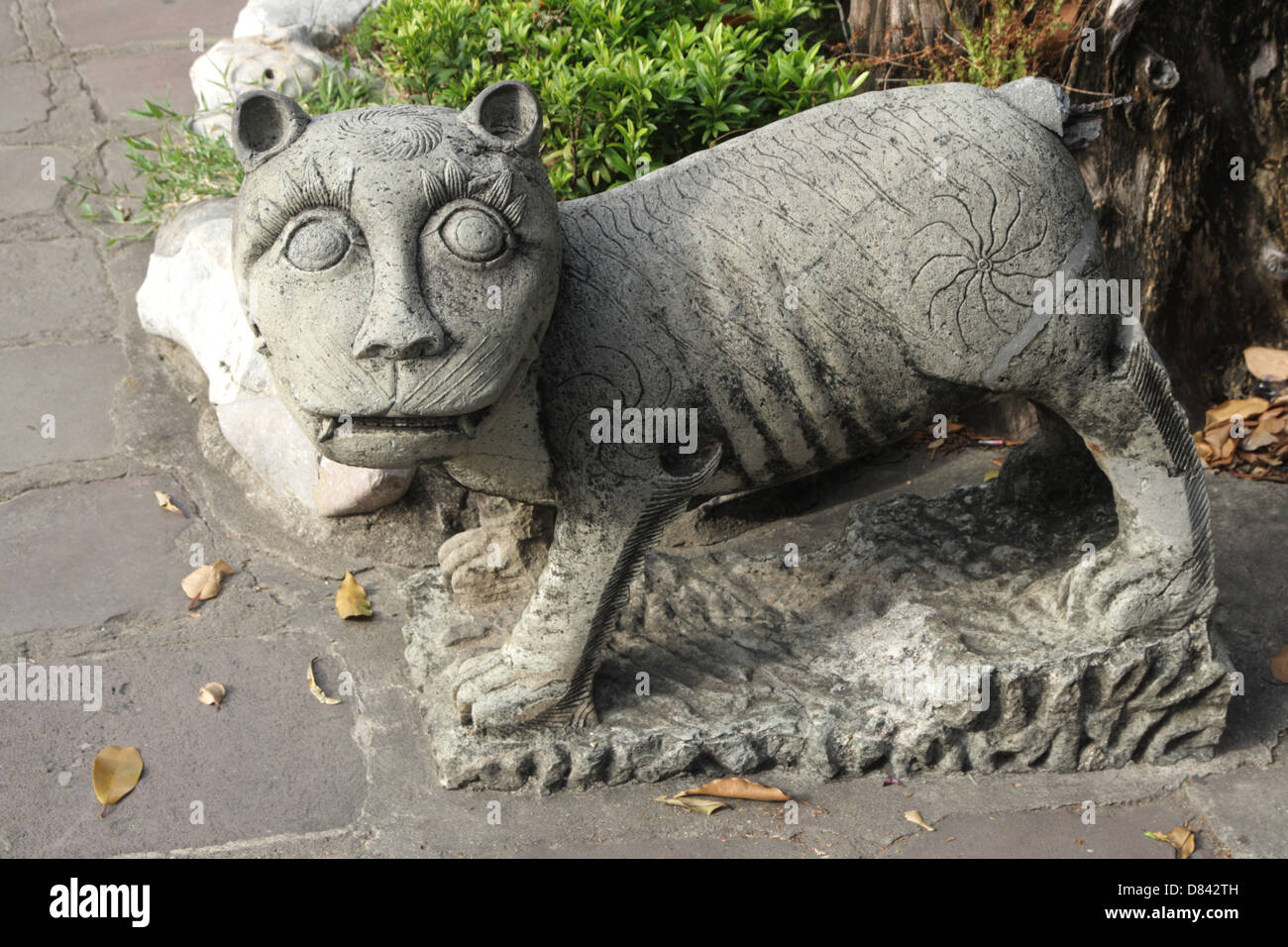 Old Chinese tiger statue at Wat Pho temple in Bangkok , Thailand Stock