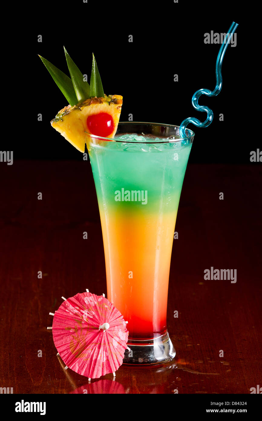 colorful tropical cocktail with layers and fruit garnishes Stock Photo Alamy