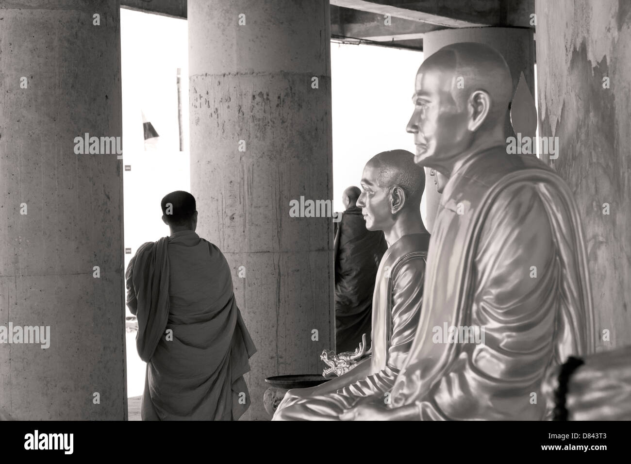 PHUKET, THAILAND FEBRUARY 15 2013: Buddhist monks walk by statues of monks past at the Big Buddha Monument Stock Photo