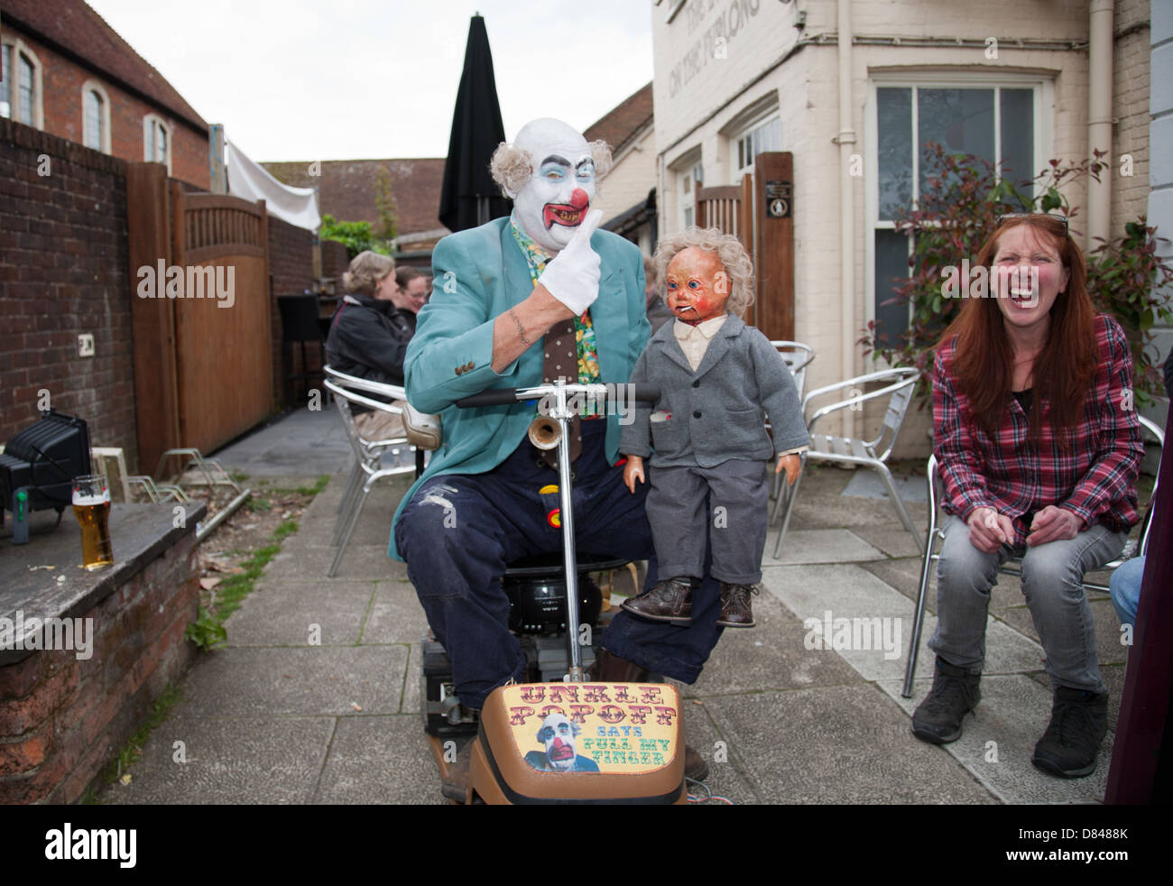 Evil looking clown at a festival in Ringwood Hampshire England United Kingdom Stock Photo