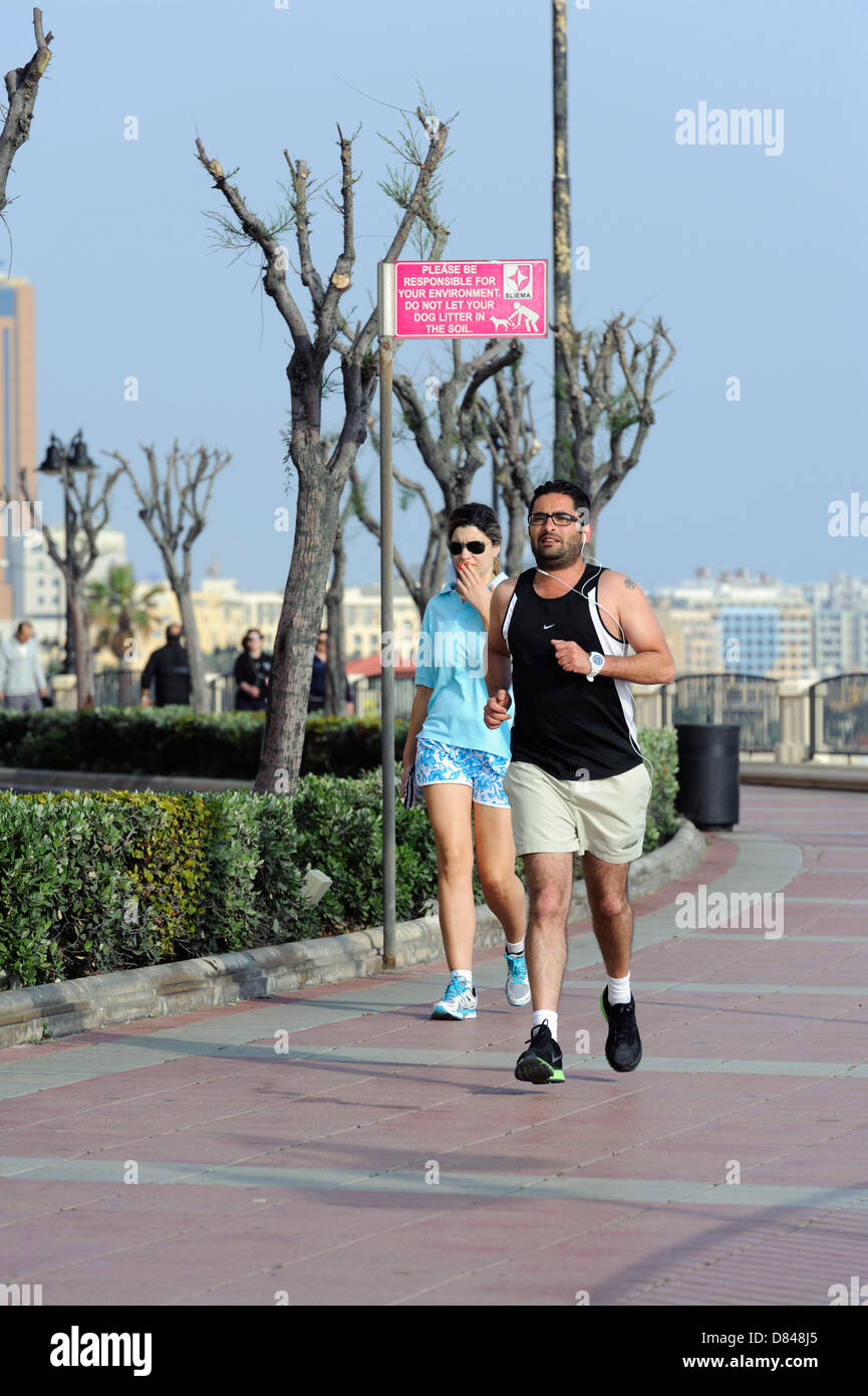 Jogger at Peace Boulevard an the boardwalk in Sliema, Malta Stock Photo