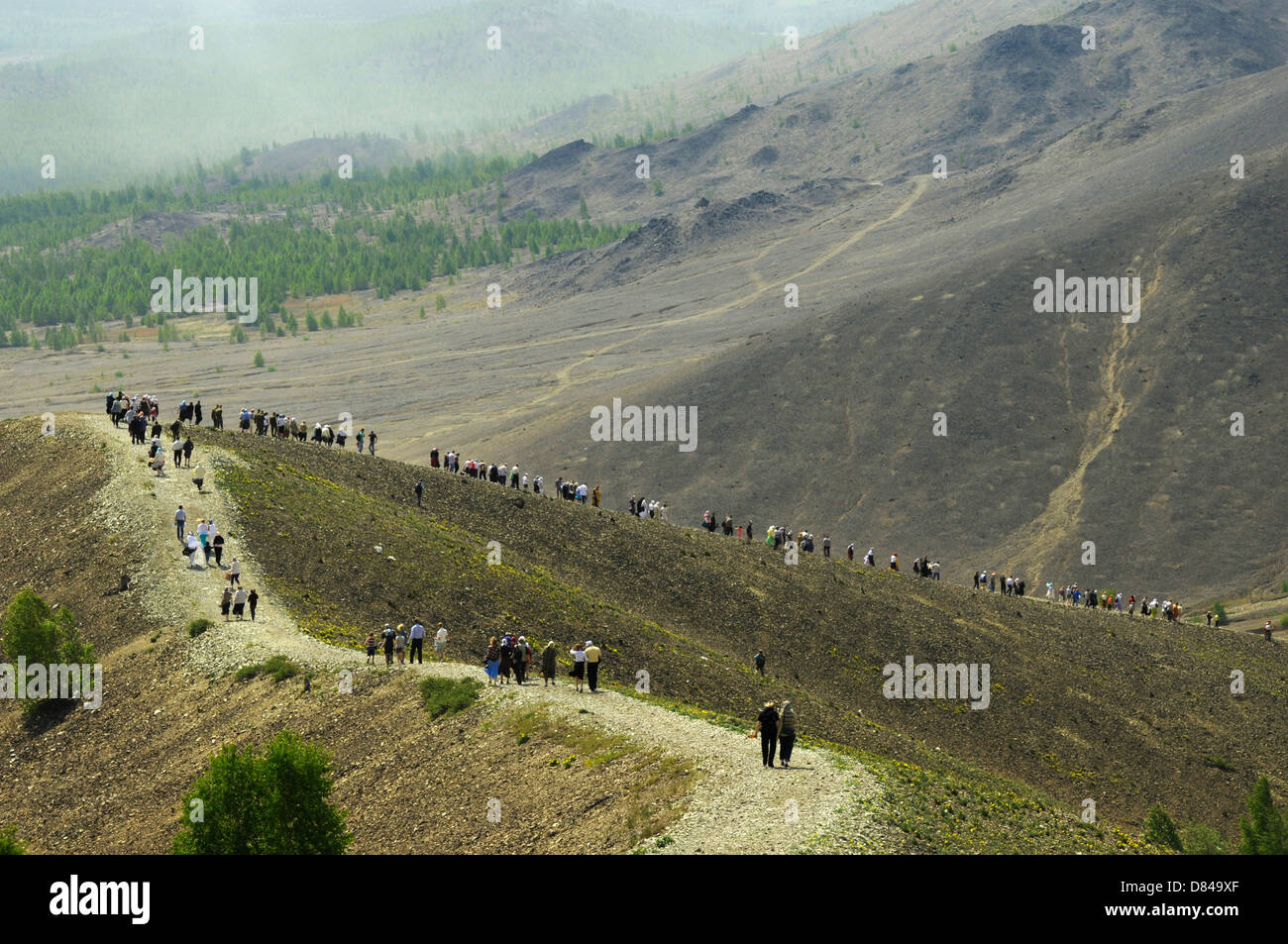 The orthodox procession walks at the mountain slope near the most polluted town in Russia Karabash. Chelyabinsk region, Russia Stock Photo