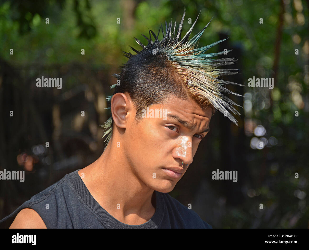 A young man with a Mohawk hairdo and a nose ring in Union Square Park, New York City Stock Photo