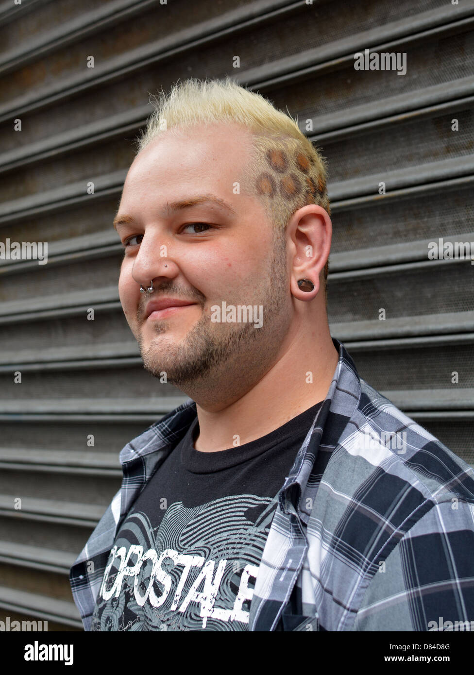 Man with mohawk hairdo and leopard coloring in his hair in Midtown Manhattan Stock Photo