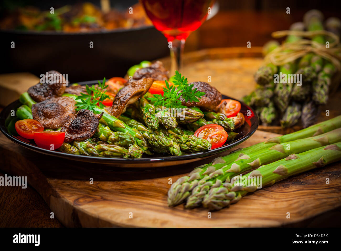 Roasted mushrooms with green asparagus Stock Photo