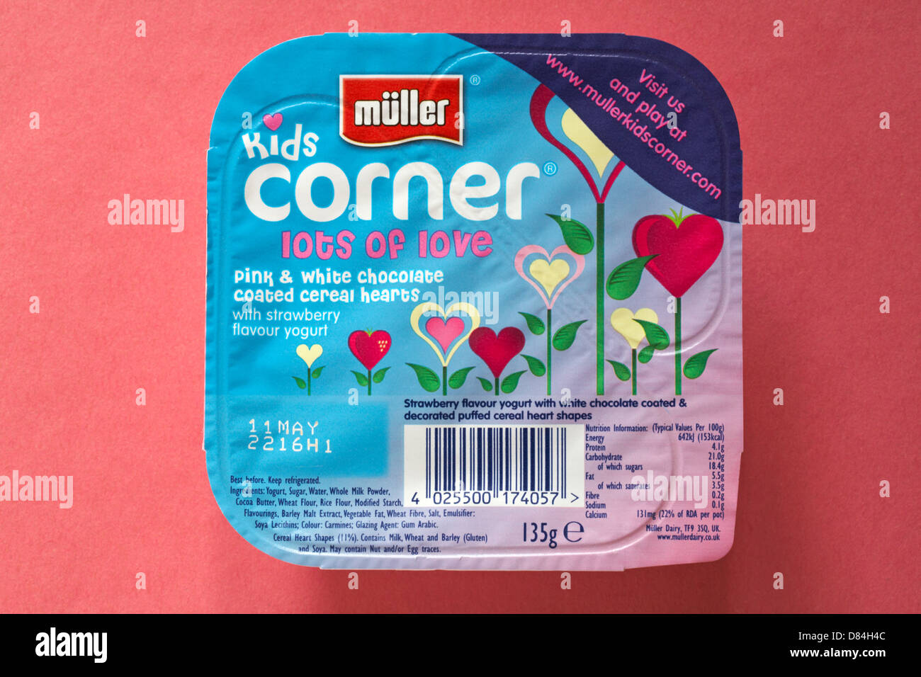 müller kids corner lots of love pink and white chocolate coated cereal hearts with strawberry flavour yogurt isolated on pink - yoghurt Stock Photo
