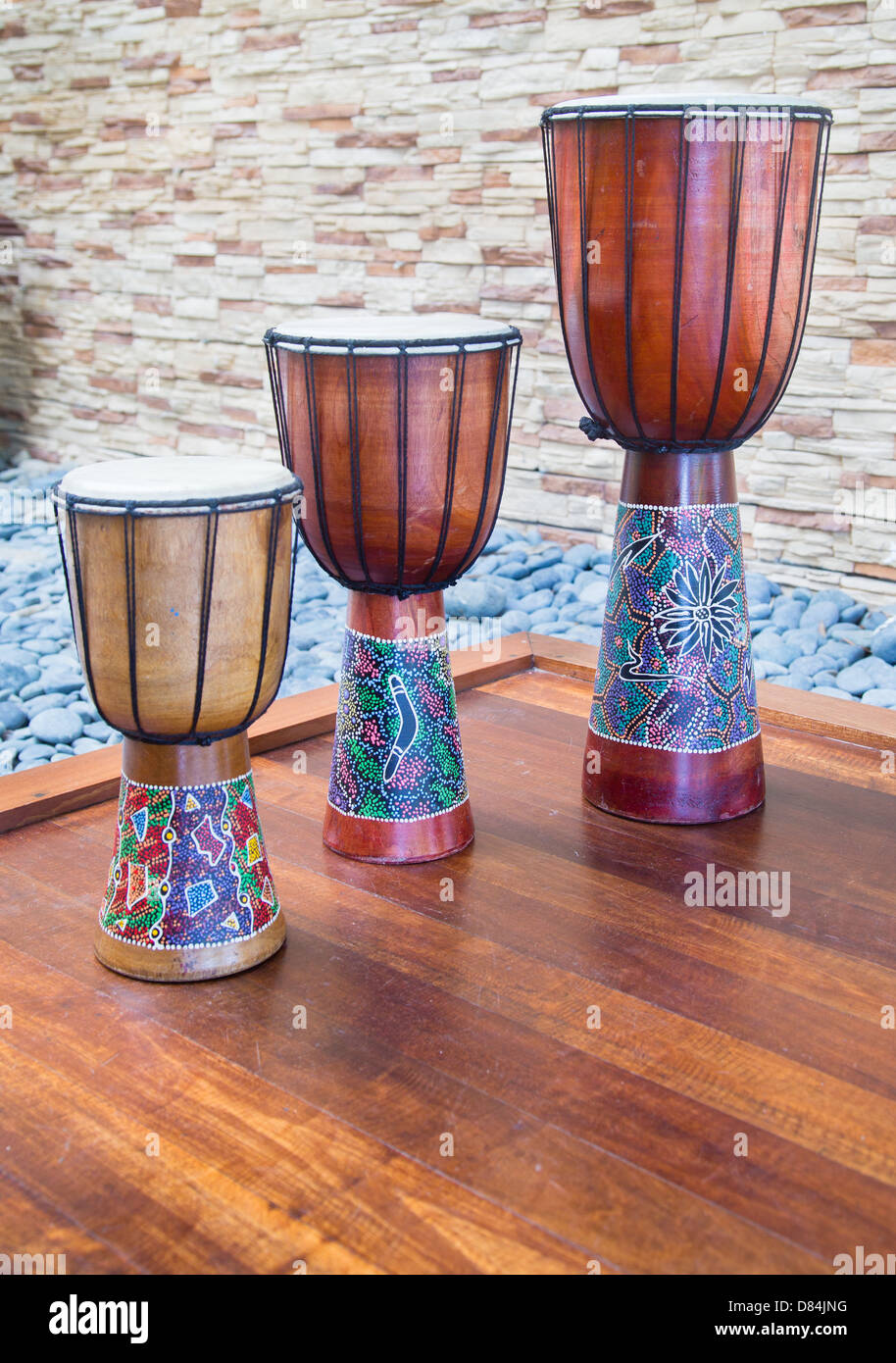 Three drums decorated with Australian aboriginal designs on a stage in a hotel lobby Stock Photo