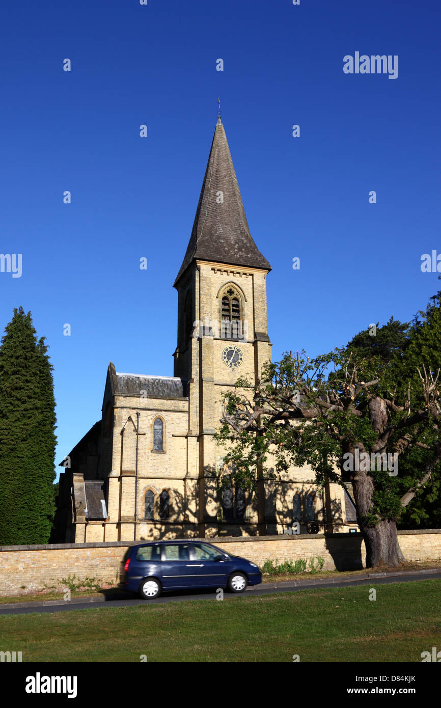 Car passing in front of St Peter's church , Southborough Common , near Tunbridge Wells , Kent , England Stock Photo