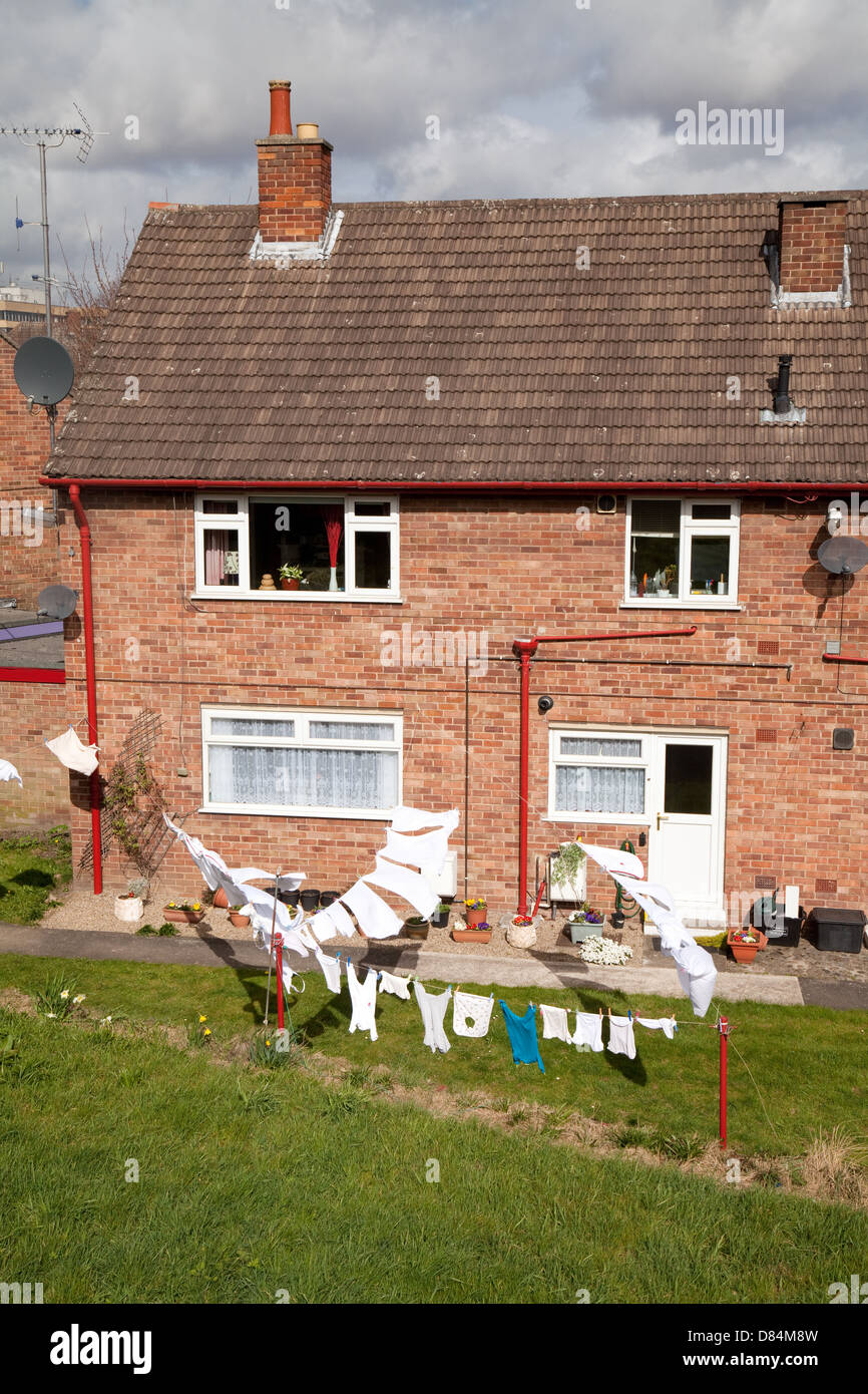 Washing drying on a washing line in the back garden of semi detached houses, York, Yorkshire UK Stock Photo