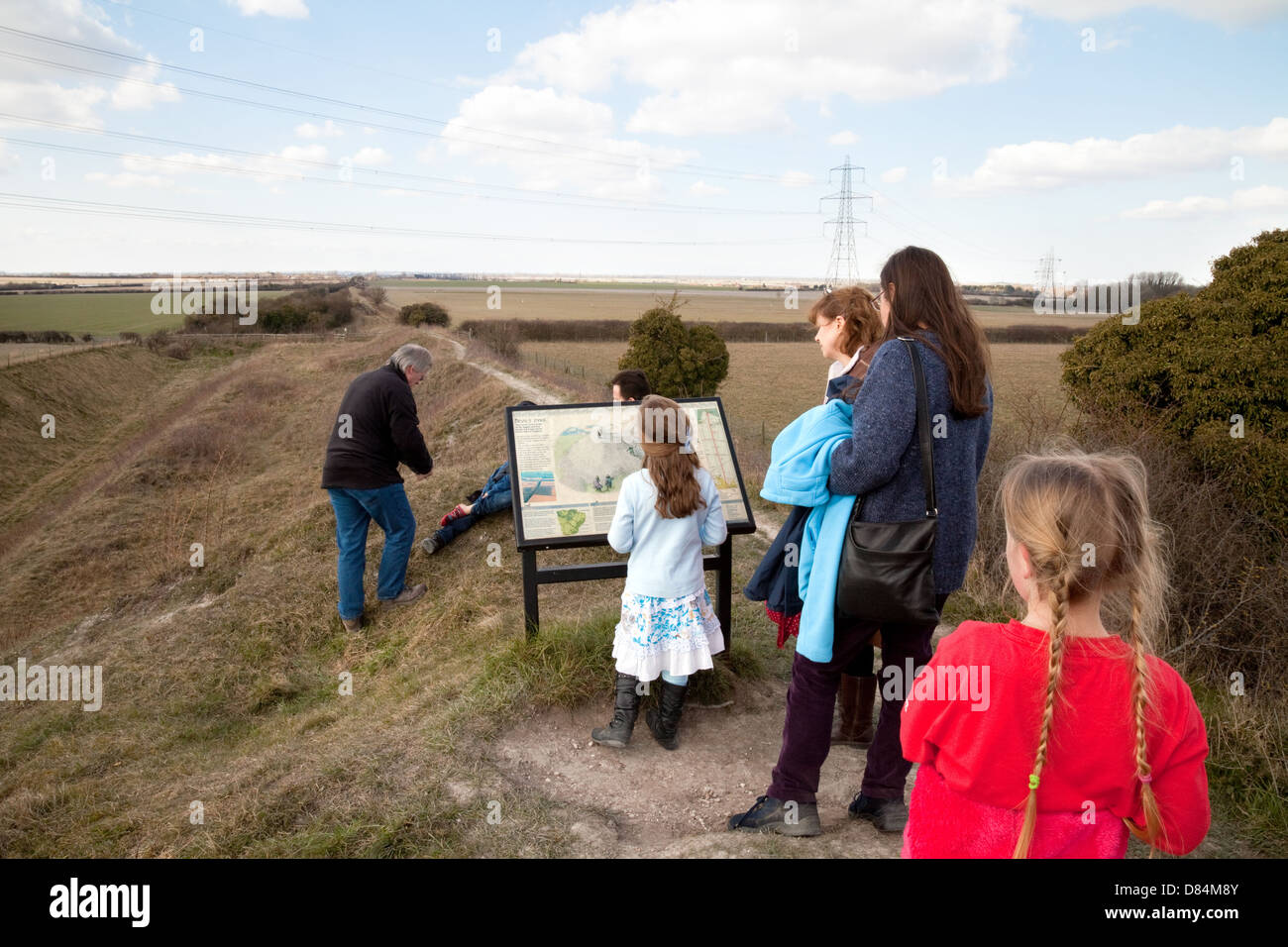 A family walking on Devils Dyke, an ancient 6th century Anglo saxon earthwork East Cambridgeshire UK Stock Photo