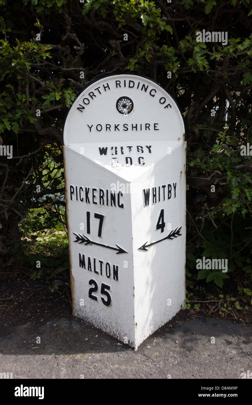 An old North Riding of Yorkshire cast iron milestone at Sleights with distances to Whitby Pickering and Malton in miles Stock Photo