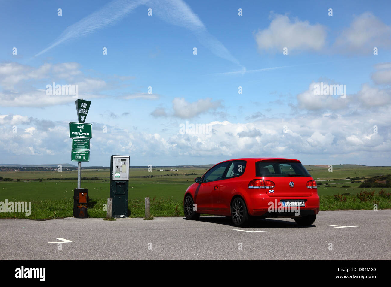 Red Volkswagen car with German numberplate in pay and display public car park near Beachy Head , East Sussex , England Stock Photo