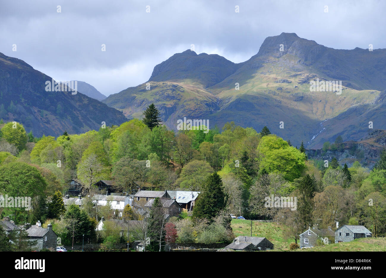 The Langdale Pikes with Elterwater in the foreground, early spring. Stock Photo