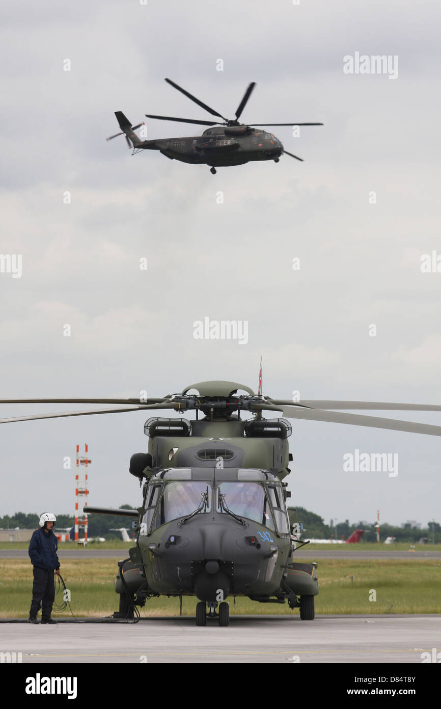 A German Army NH90 and its predecessor, the CH-53 Sea Stallion, Schoenefeld Airport, Germany. Stock Photo