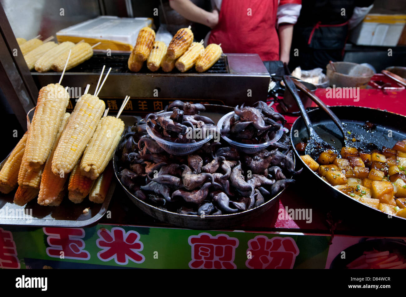 fried corn cobs, tofu and Devil Pod (seed of Trapa bicornis), food stall at Wangfujing Snack Street in Dongcheng, Beijing, China Stock Photo
