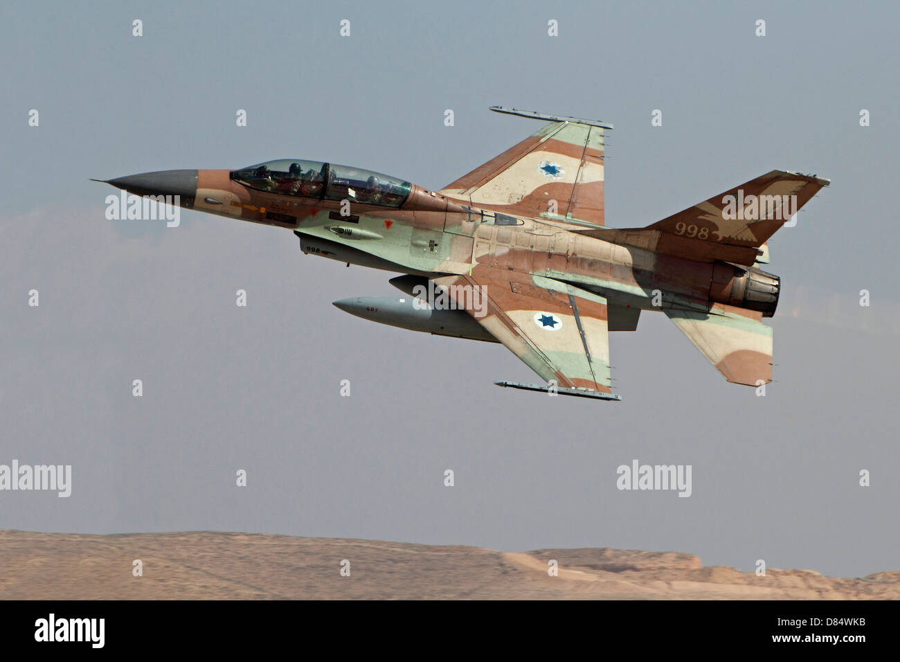 An F-16B Netz of the Israeli Air Force in flight over Nevatim Air Force Base, Israel. Stock Photo