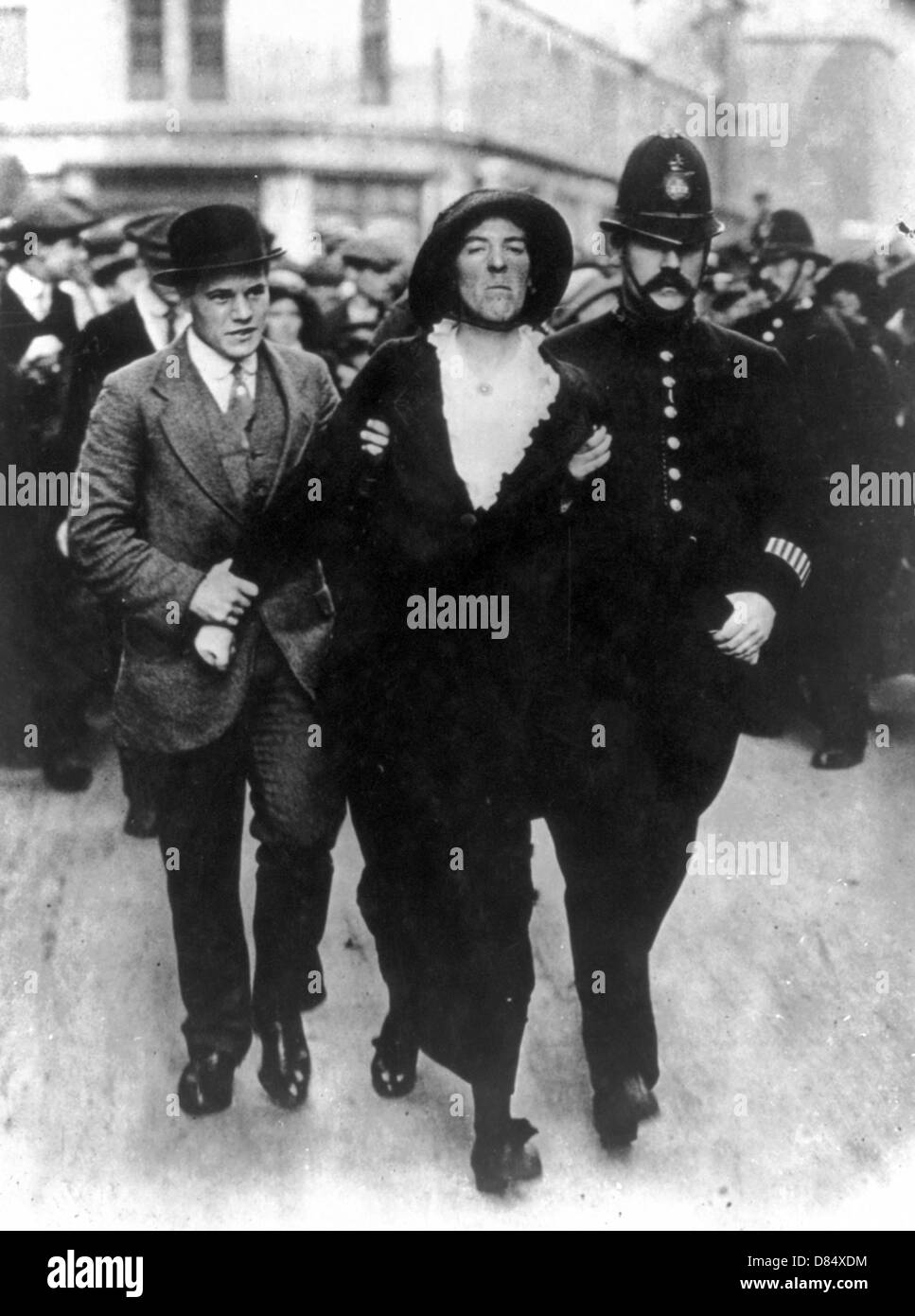 Arrest of Suffragette by policemen and plain clothesman escorting woman, London, UK Stock Photo