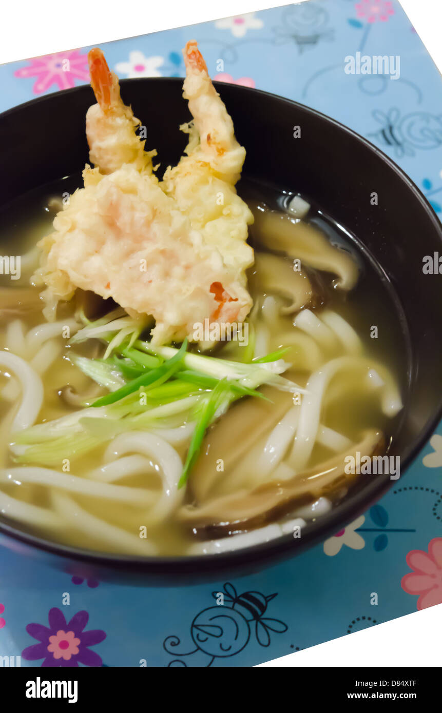 Udon noodles with shrimp tempura in black bowl , Japanese food Stock Photo