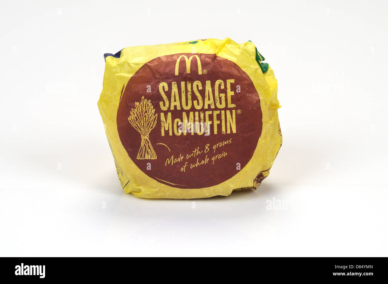 McDonald's  Sausage McMuffin takeaway breakfast sandwich in paper wrapper on white background, cutout. USA Stock Photo