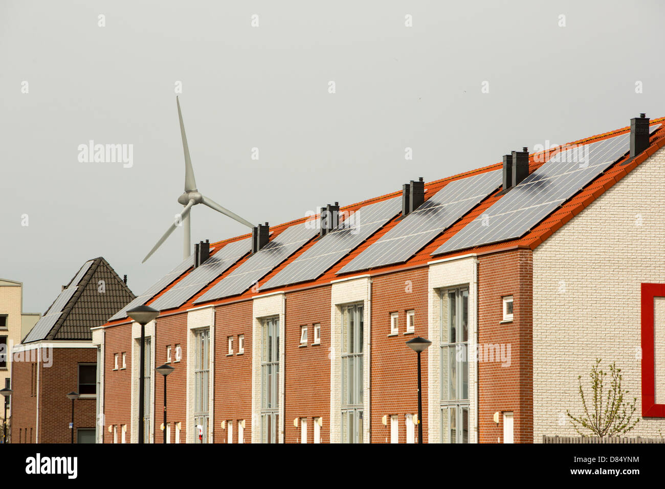 Houses with solar panels and a wind turbine in Sun City in Heerhugowaard, Holland,one of the greenest suberbs in the world. Stock Photo