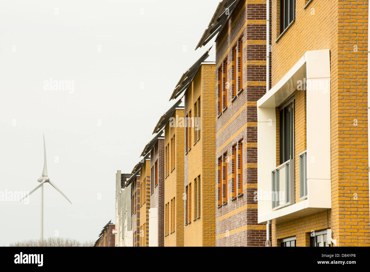 Houses with solar panels and a wind turbine in Sun City in Heerhugowaard, Holland,one of the greenest suberbs in the world. Stock Photo