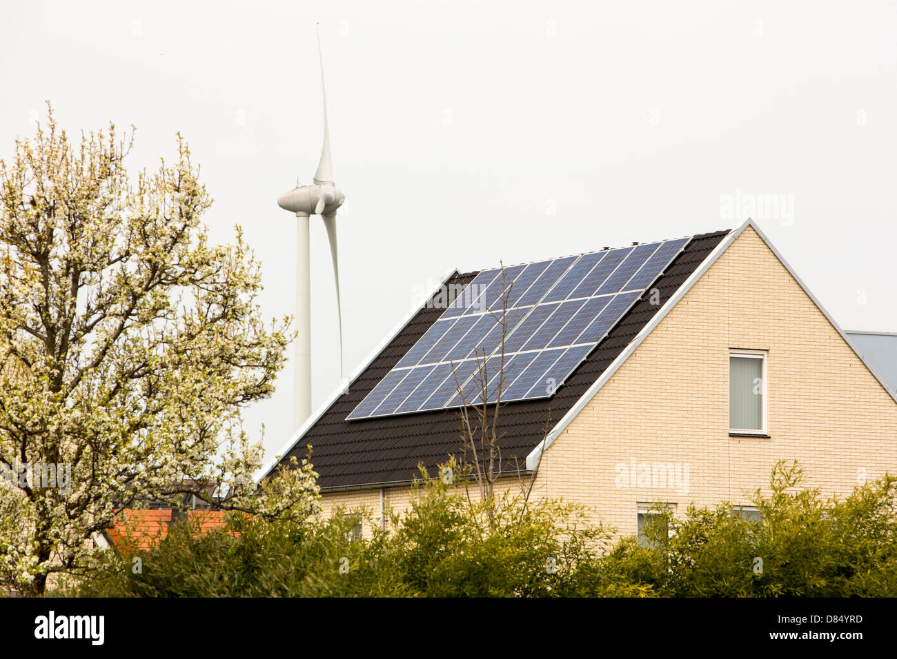 Houses with solar panels and a wind turbine in Sun City in Heerhugowaard, Holland,one of the greenest suberbs in the world. Stock Photo