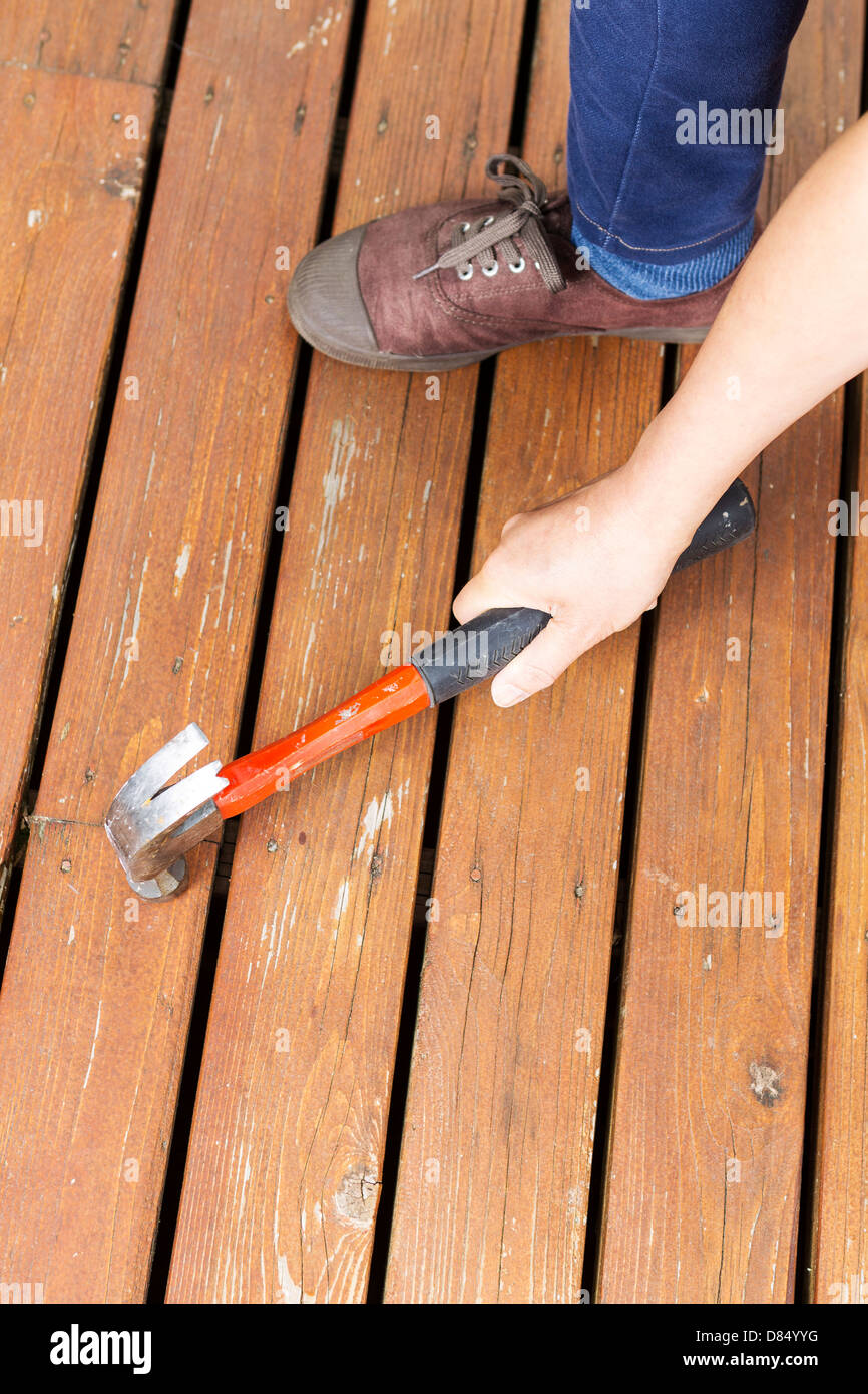 Vertical Photo Of Female Hand Work Shoes And Hammer Adjusting