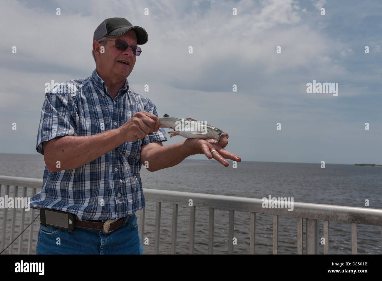 Man fishing on the public pier at Cedar Key Florida on the Gulf coast