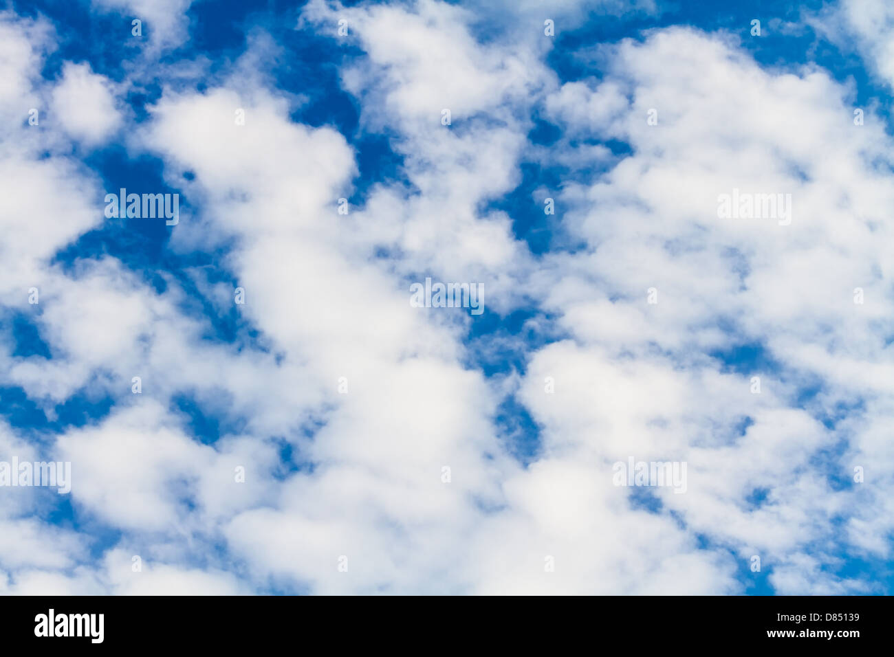 Puffy white clouds against a perfect blue sky Stock Photo - Alamy