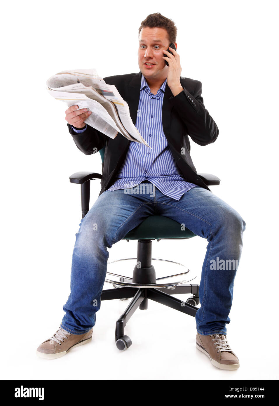A man looks surprised, shocked while reading a newspaper speek phone white background Stock Photo