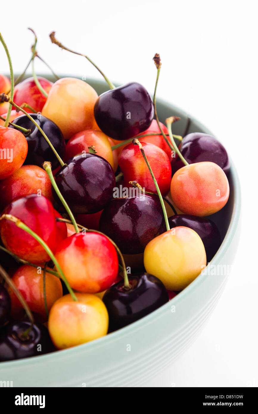 Rainier and black cherries mixed in a a green ceramic bowl. Stock Photo