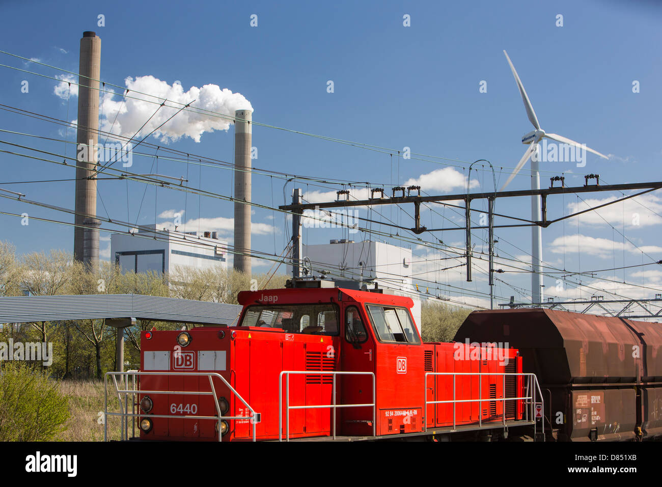 Climate change heaven and hell of a wind turbine with emissions from a coal fired power station in Amsterdam, Netherlands. Stock Photo