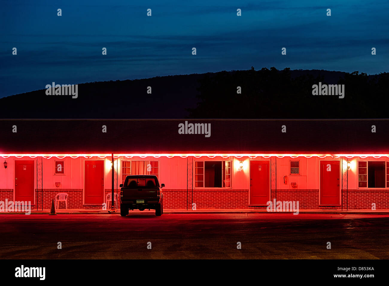 Budget motel exterior at dusk. Stock Photo