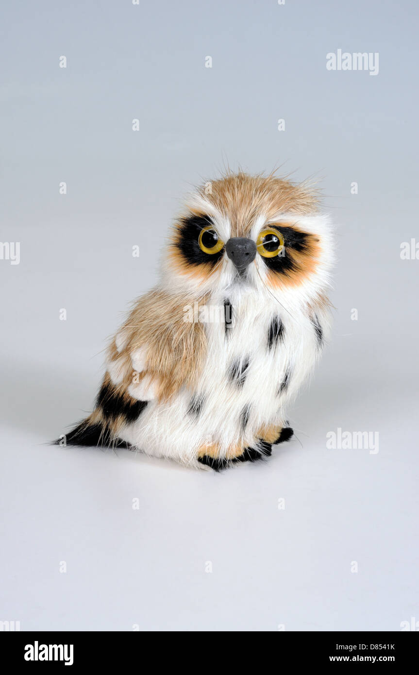 Owl standing ornament made from real fur against a plain background