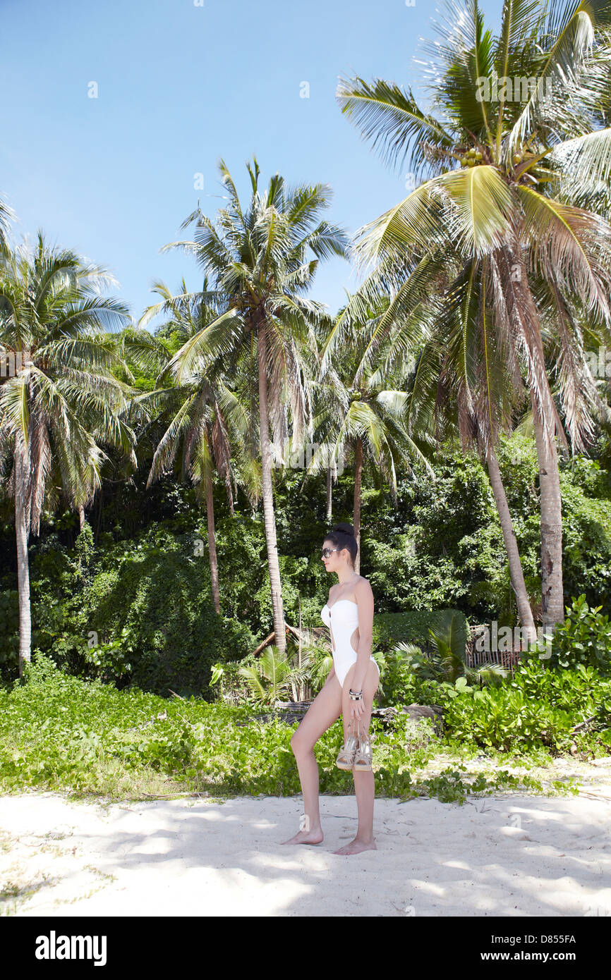 young woman posing in swimsuit on beach. Stock Photo