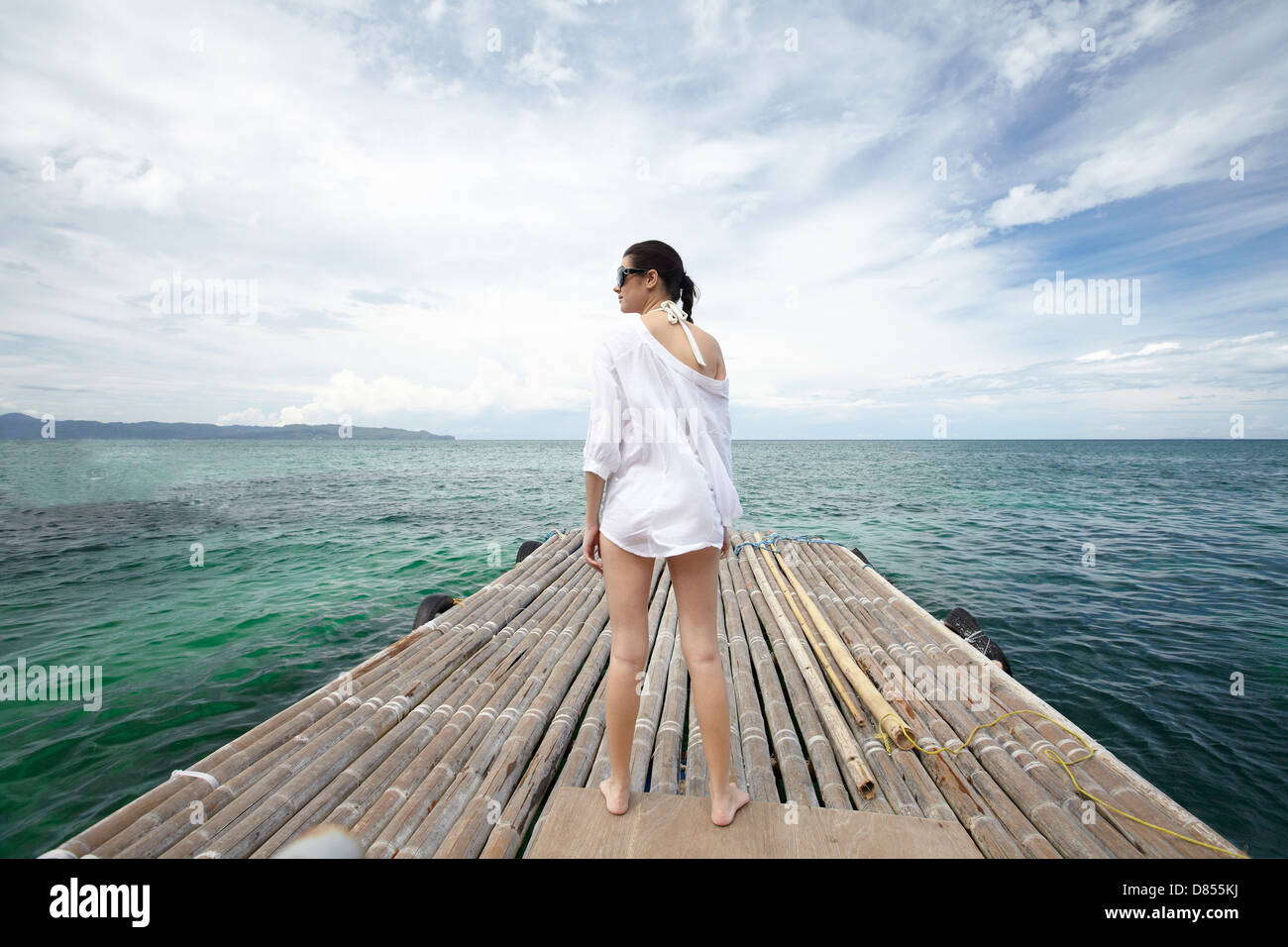 young woman posing in swimsuit on dock. Stock Photo