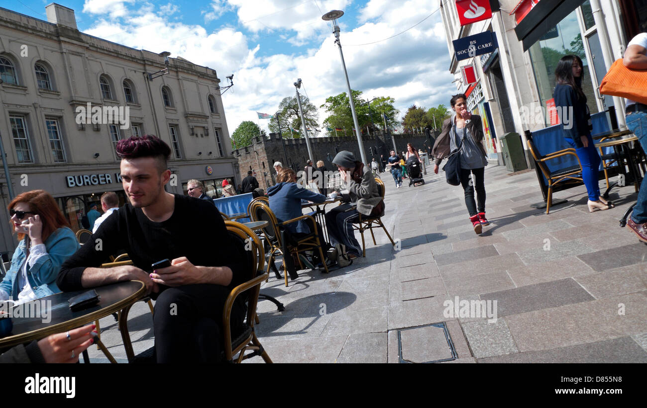 People sitting at tables outside cafes and restaurants in Cardiff City Centre Wales UK KATHY DEWITT Stock Photo