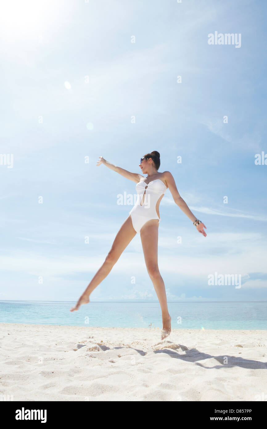 young woman posing in swimsuit on beach. Stock Photo