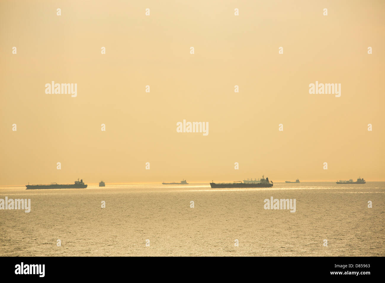 Oil and gas tankers waiting off Amsterdam to import fossil fuels. Stock Photo