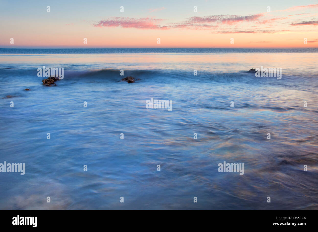 Stunning Summer sunset over ocean with rocks and vibrant colors Stock ...