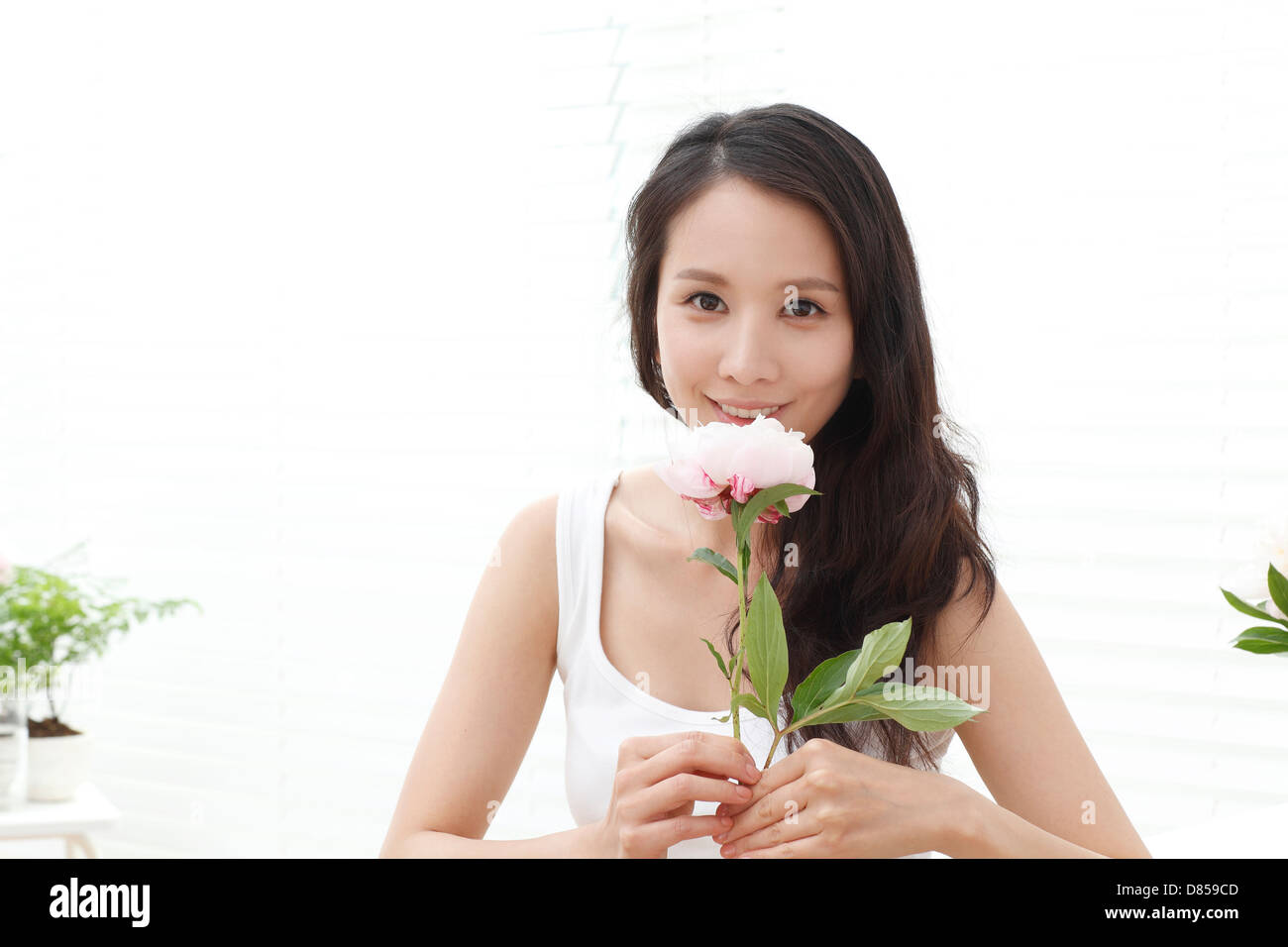 young woman smelling flower Stock Photo - Alamy
