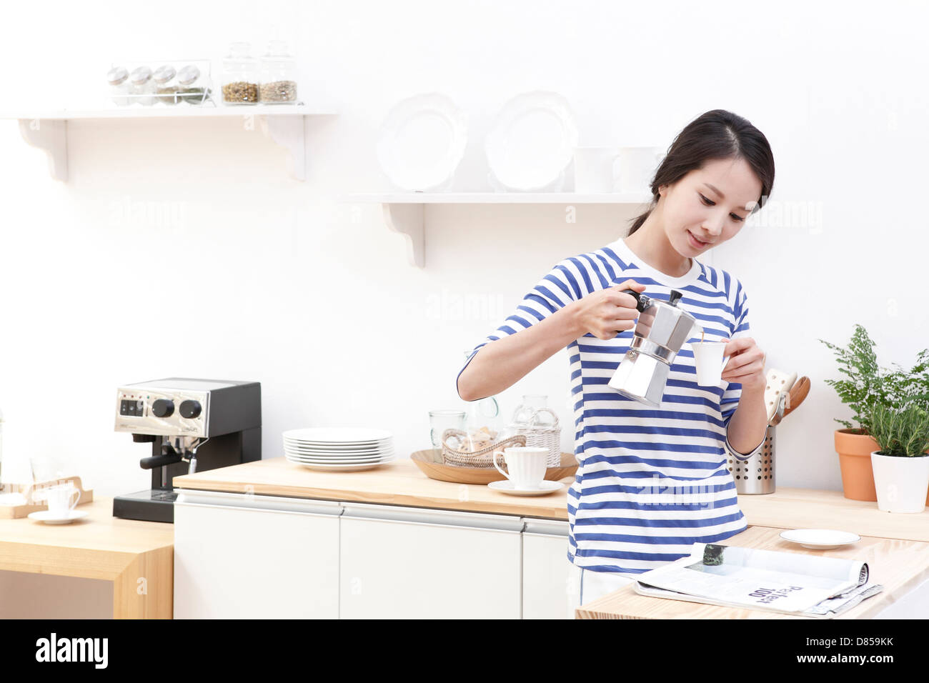 young woman pouring cup tea. Stock Photo