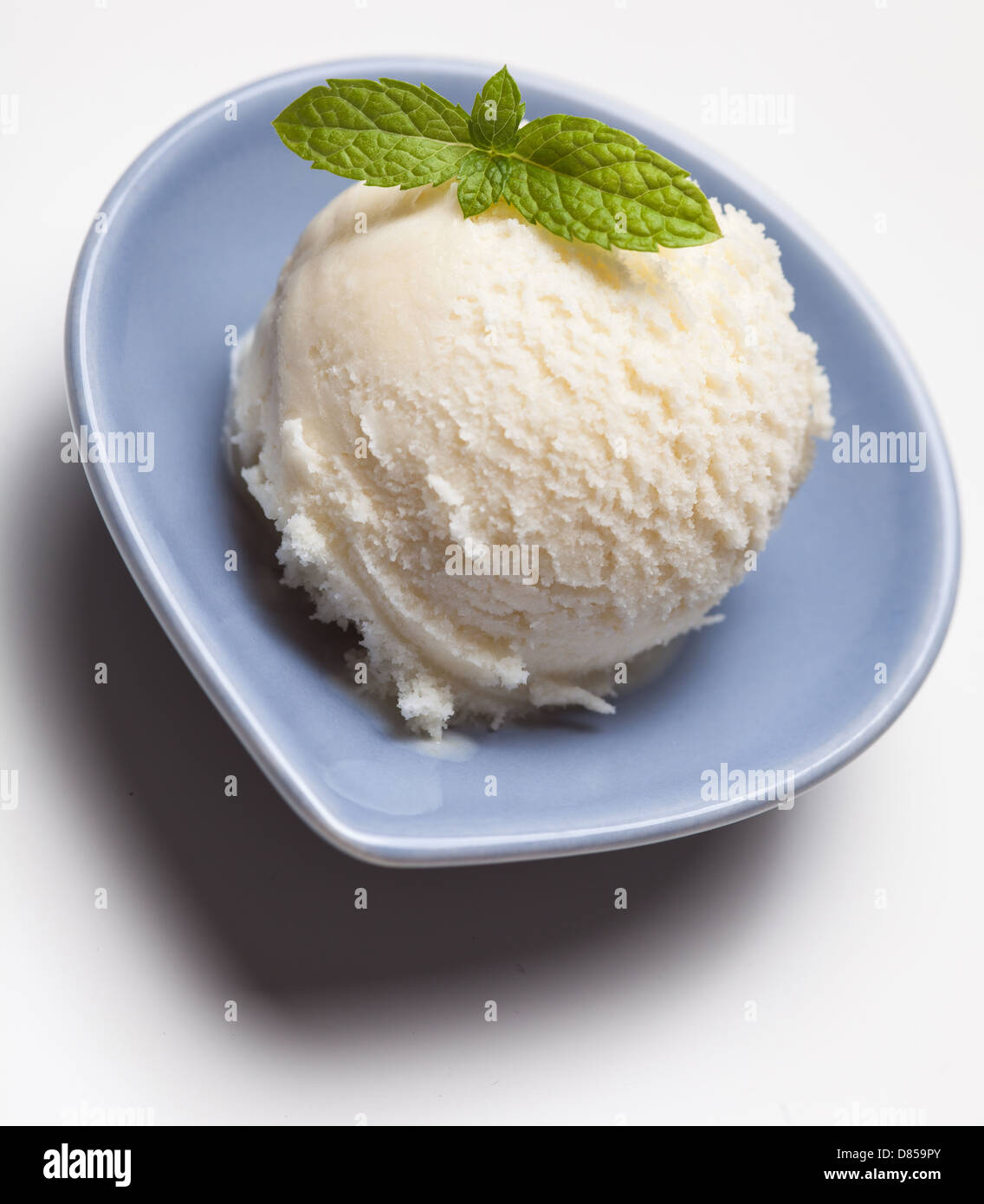 Scoop of lemon ice cream with peppermint decoration Stock Photo