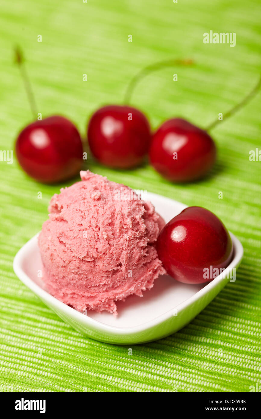 A scoop of cherry ice cream with sweet cherries Stock Photo