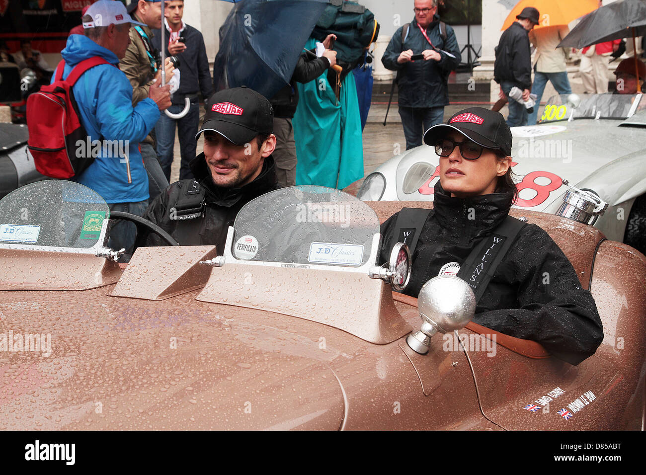 Supermodel David Gandy with Yasmin Le Bon taking part in a very wet 2013 Mille Miglia road race driving a 1950 Jaguar XK120 Stock Photo