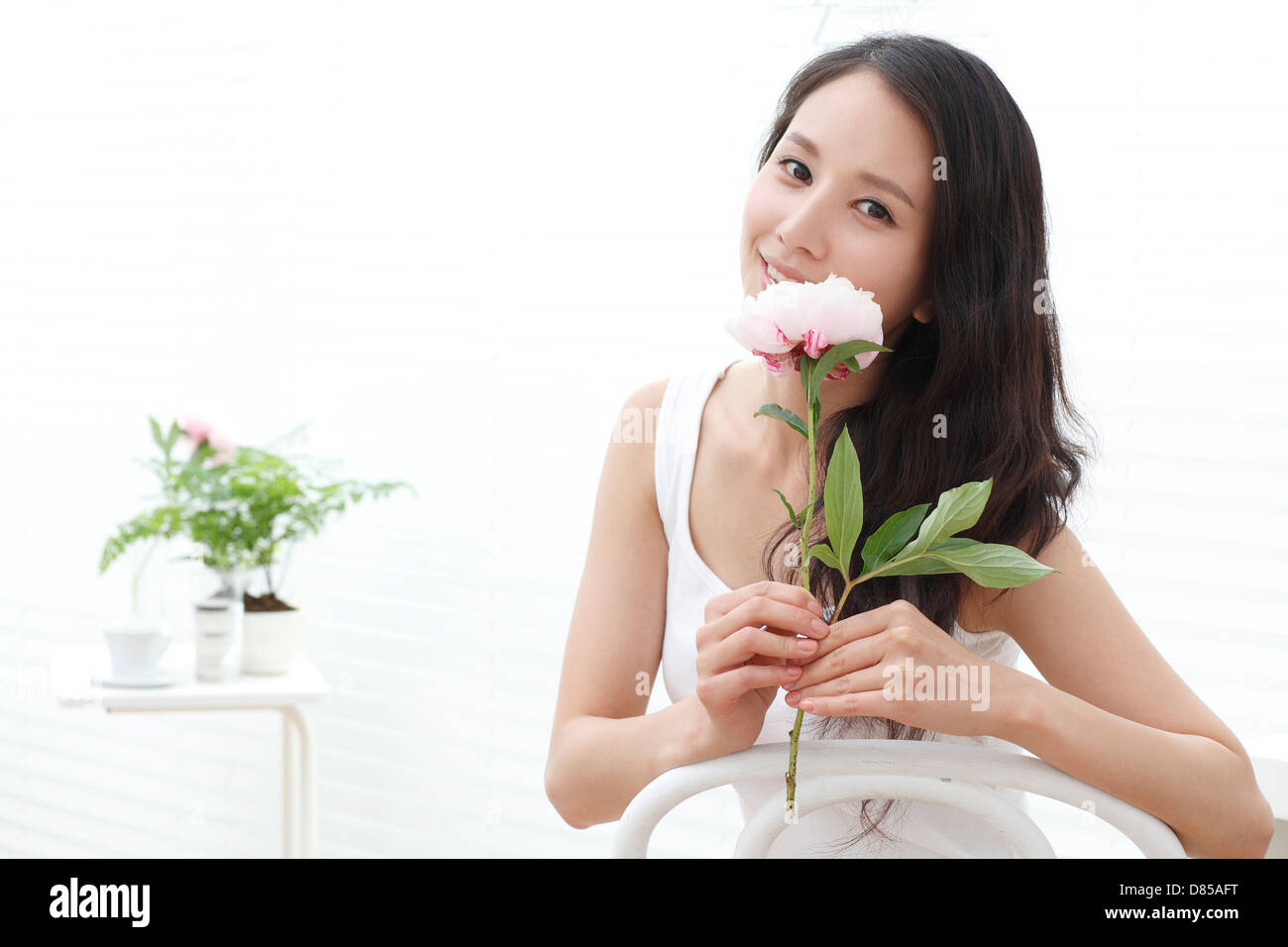 young woman smelling flower Stock Photo - Alamy