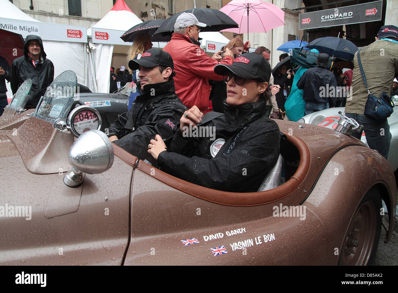 Supermodel David Gandy with Yasmin Le Bon taking part in a very wet 2013 Mille Miglia road race driving a 1950 Jaguar XK120 Stock Photo