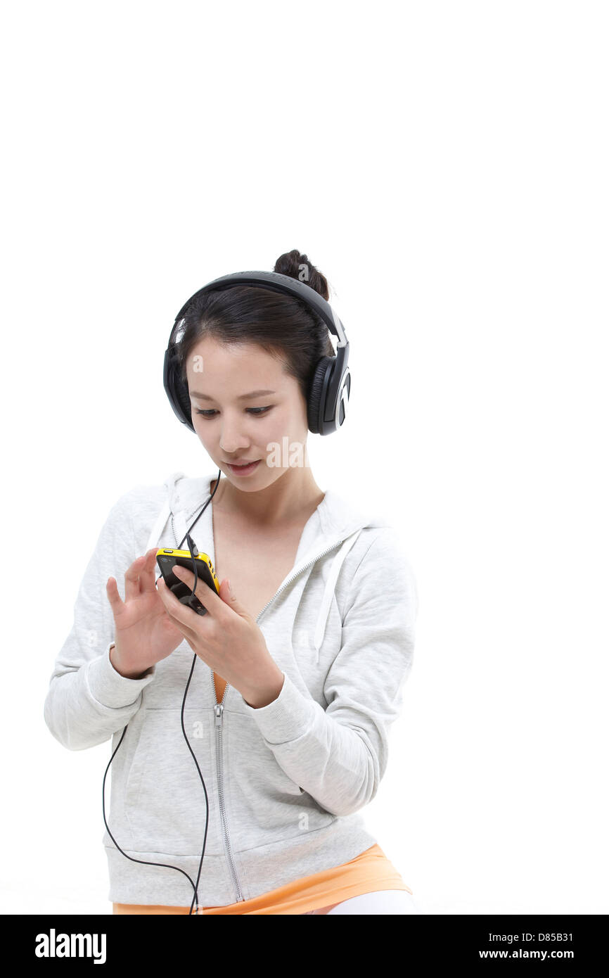 young woman sitting listening to music Stock Photo - Alamy