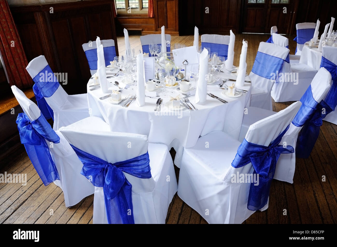 Table And Chairs Decorated In Blue And White At Wedding Reception